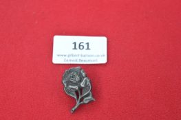 A German Third Reich Tinnie badge in the form of a rose, slightly variant die-stamped pattern,