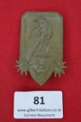 An Austrian commemorative tinnie badge, bronze-coloured alloy, shield-shaped with edelweiss