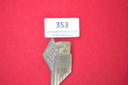 Gebietssportfest Nürnberg 1934 Badge – A pressed brass eagle-shaped badge clutching a swastika,