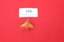 A modern gilt metal lapel badge in the form of an aircraft in flight, fitted with clutch back