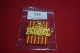 German 25-year service commemorative badge, gilt with helmet and crossed weapons motif above shield,