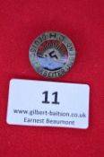 A Hitler Youth “Deutsche Arbeiter Jugend” badge, circular bronze and enamel issue with red rising