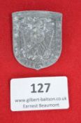 A Third Reich Westwall donation badge, grey shield-shaped pressed alloy issue with embossed eagle