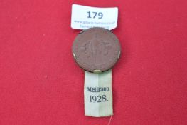 Bronze medal with green/white ribbon. Obverse depicts soldier, inscription “WIDERSETZUNGSFEIER …