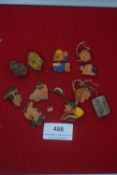 A mixed group of German WWII WHW painted composition day badges, caricature heads, animals and other