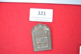 Labour Front Commemorative Plaque – A rectangular arched-top pressed metal plaque, with central