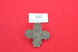 A Nazi Party Day badge, bronze-coloured cross-shaped issue inscribed “NSDAP Gauparteitag Gau Rhein