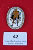 A German enamelled event badge, oval white enamel issue for the Internationale Handwerks Ausstellung