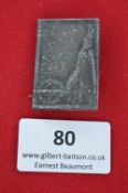 A German Third Reich Day Badge, rectangular grey alloy issue depicting Germania with raised sword