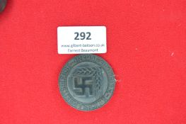Reichsarbeitsdienst Youth Service Badge – A circular pressed metal badge with swastika and wheat