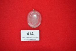 An oval glass pendant with bust portrait of Adolf Hitler, inscribed at the base.