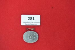 A German WWII-era membership badge, oval zinc construction. Reverse marked 
