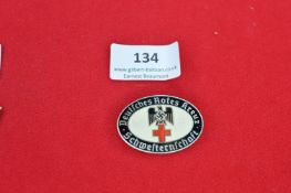 A German Red Cross Nurses’ Badge, oval white enamel example with black legend “Deutsches Rotes Kreuz