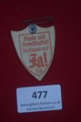 A German political cardboard day badge, shield form, printed in red “Friede und Gerechtigkeit! Ich