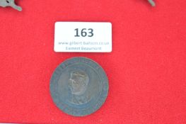 A German Third Reich commemorative medallion-badge, circular bronze-coloured issue with profile