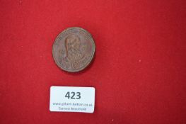 Pressed Metal Badge – A circular pressed metal badge in brown finish, depicting a bearded portrait