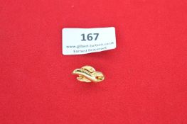 A small gilt lapel badge in the form of a stylised ribbon loop, fitted with clutch back fastening;