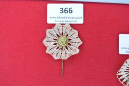 Lace and Metal Edelweiss Stickpin – A decorative stickpin comprising a circular lace rosette centred