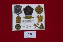 A card of assorted German WWII WHW (Winterhilfswerk) charity day badges, various forms and themes