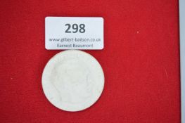 Circular Porcelain Badge with Portrait – A white glazed ceramic badge featuring a raised side-