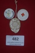 A group of three German WWII WHW porcelain day badges, including: circular example with blue flowers