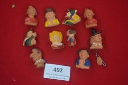 A group of German WWII WHW porcelain character head day badges, caricature busts including Max,