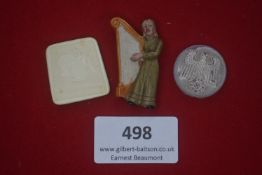 Three German WWII WHW day badges, comprising: a pressed-plastic rectangular badge with infant and