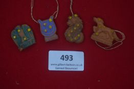 A set of four German WWII WHW porcelain day badges, constellation motifs, painted examples including