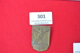 Pressed Metal Day Badge “NSDAP Hesselberg 1933” – A shield-shaped pressed brass badge with raised