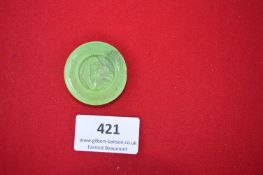 Plastic Mothers’ Day Badge – A circular green plastic badge moulded with a relief of a mother and