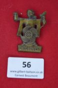 A German Third Reich Oktoberfest Day Badge, cast bronze alloy, depicting a Munich Child holding a
