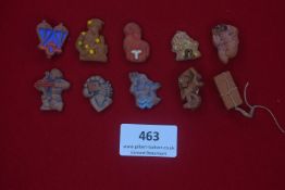 Collection of ten German WWII terracotta badges with astrological themes — Including signs of the