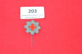 German Red Cross Edelweiss Flower Badge – grey metal eight-petal flower with central red enamel