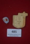 Two German WWII WHW day badges, including: a pressed ceramic shield inscribed “Kur Hessen” with