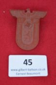 A German day badge, brown Bakelite issue in the form of a shield surmounted by eagle and swastika,