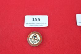 A German Reichsarbeitsdienst (RAD) enamel badge, circular form with red enamel border inscribed “N.