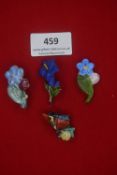 Four German WWII porcelain floral and insect badges — Colourful examples including flowers inscribed