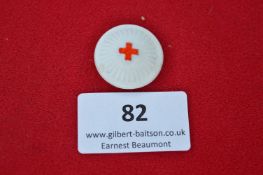 An East German (DDR) Red Cross commemorative medallion, white ceramic issue with central embossed