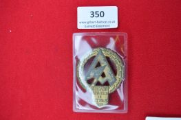 Pressed Metal Brigade Aufmarsch Badge – A circular oakleaf wreath with stylised central “SA”