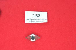 A Hitler Youth (HJ) membership badge, diamond-shaped enamel issue in red and white with central