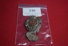 A German veterans’ association badge, silvered metal oval with crowned crest and coloured rose to