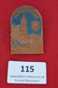 A German Day Badge, pressed brown plastic issue with coloured highlights, depicting the town of