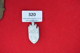 Rectangular-Topped Shield Badge – Light alloy pressed badge, shaped as a castle tower with pointed