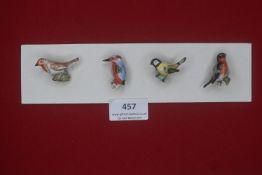 Four German WWII ceramic bird badges — Finely modelled and hand-painted birds including robin,