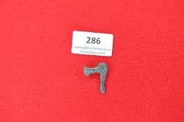 Cast Metal Commemorative Tinnie Badge in the form of a War Axe – A grey-metal badge shaped as a