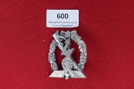 Luftwaffe Ground Assault Badge – A silvered metal oval badge depicting an eagle grasping a