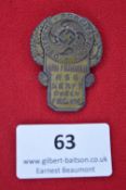 A German Third Reich DAF/KdF Badge, bronzed tombak issue, cogwheel with swastika, oak wreath