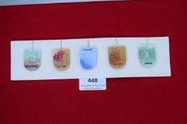 A German WWII WHW set of small ceramic shields depicting castles and landscapes, including Schloss