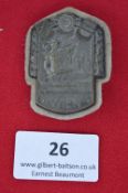 An Austrian shooting festival commemorative badge, shield-shaped grey alloy issue with relief figure