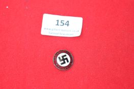 A National Socialist German Workers’ Party (NSDAP) membership badge, circular enamel issue with